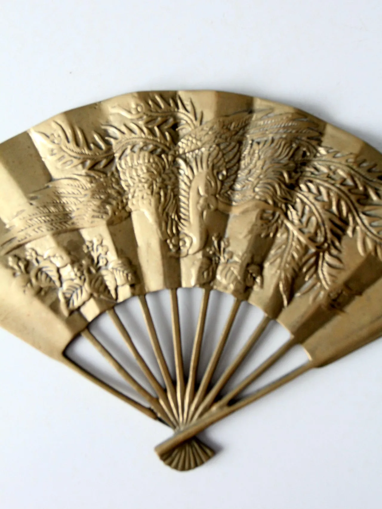 mid-century figurative brass fan wall hanging