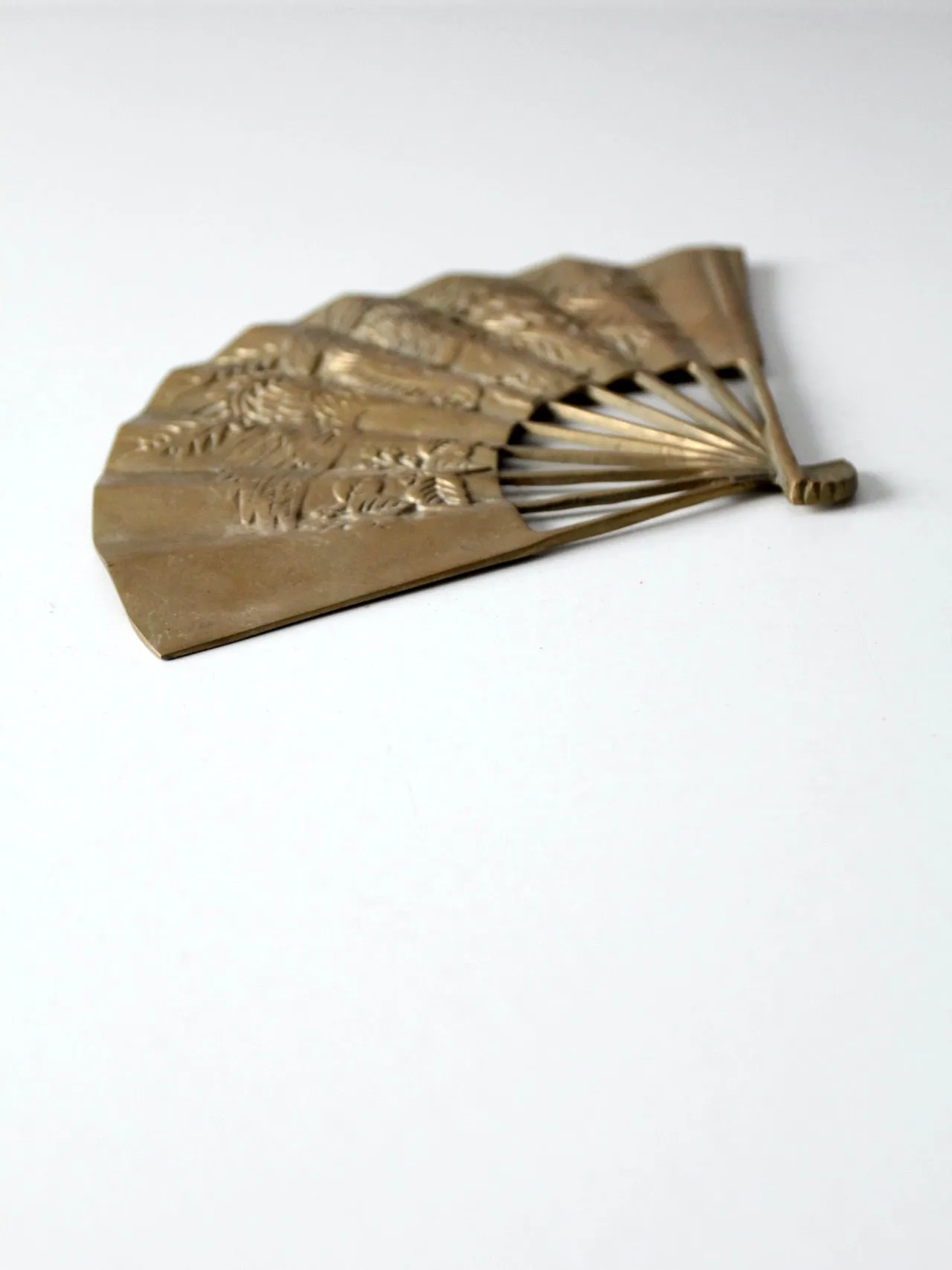 mid-century figurative brass fan wall hanging