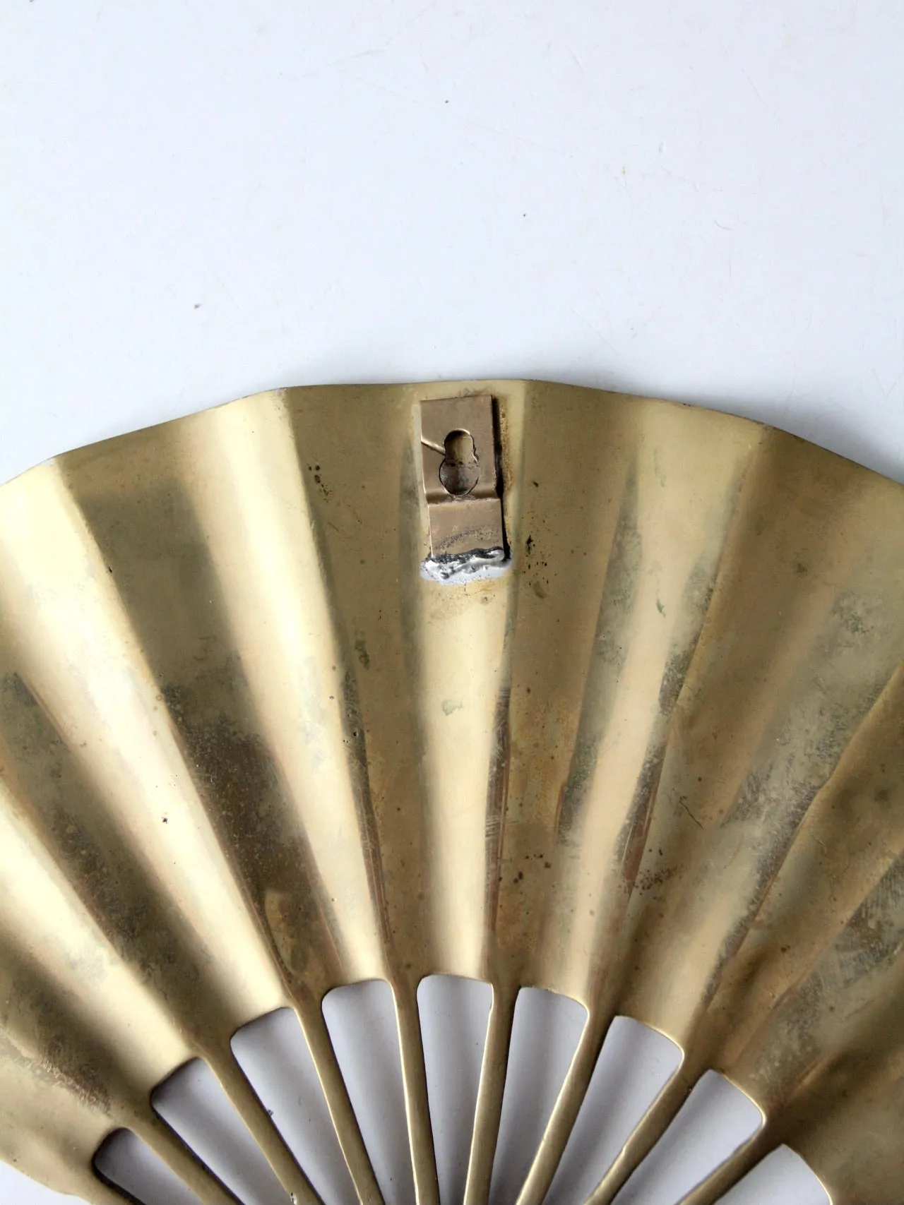 mid-century figurative brass fan wall hanging