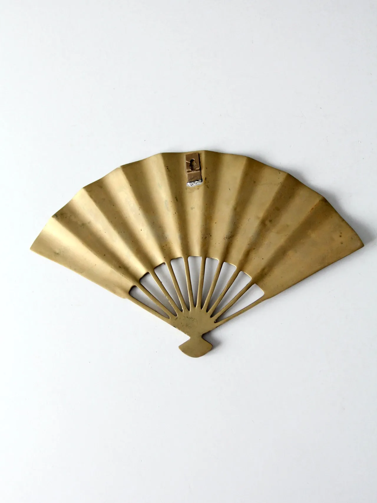 mid-century figurative brass fan wall hanging